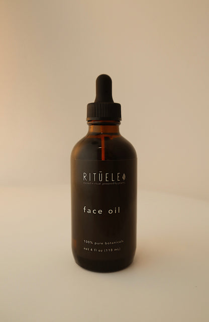 Bottle of Rituéle face oil on a beige background