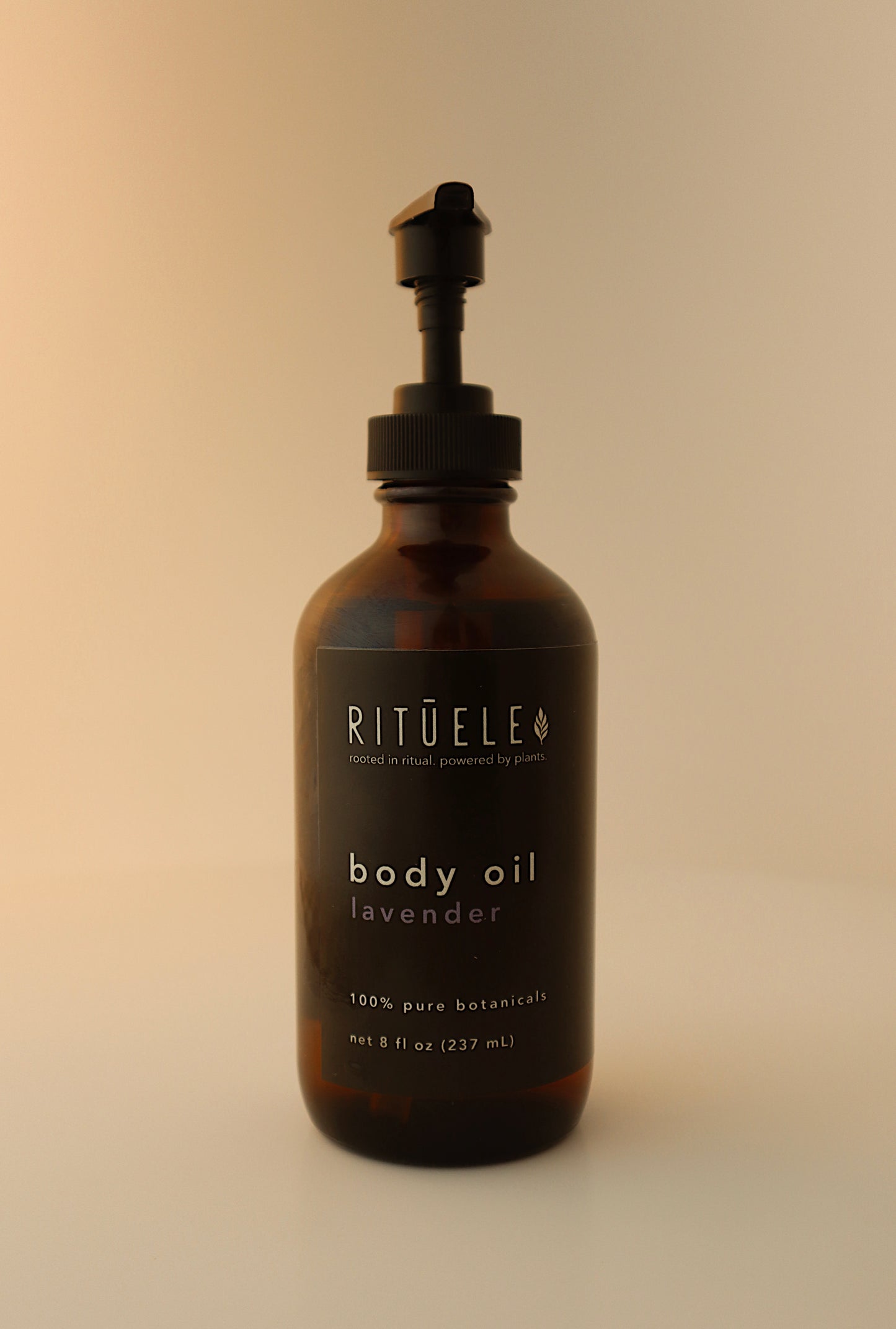 Brown bottle of Rituel body oil lavender on a beige background