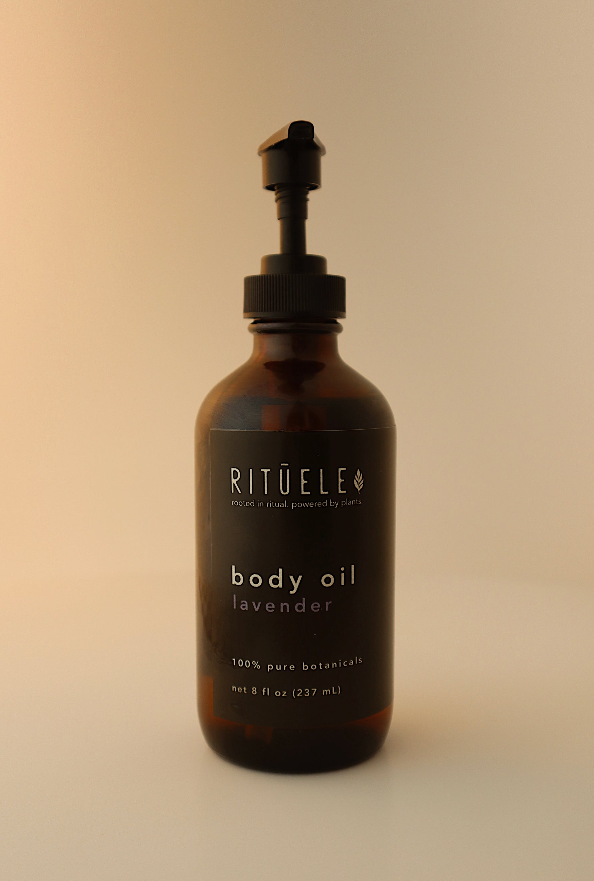 Brown bottle of Rituel body oil lavender on a beige background