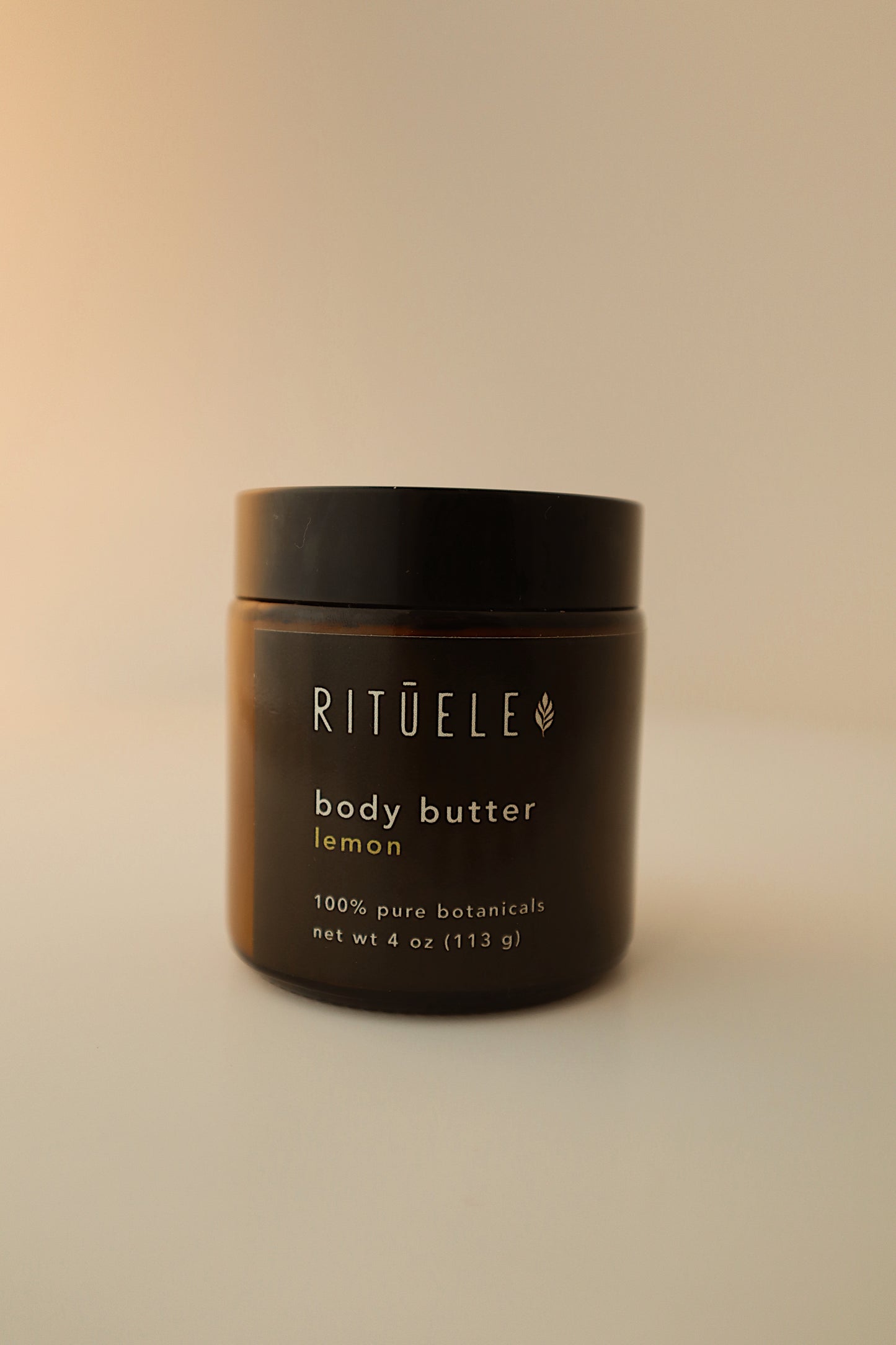 Rituelle body butter container on a beige background
