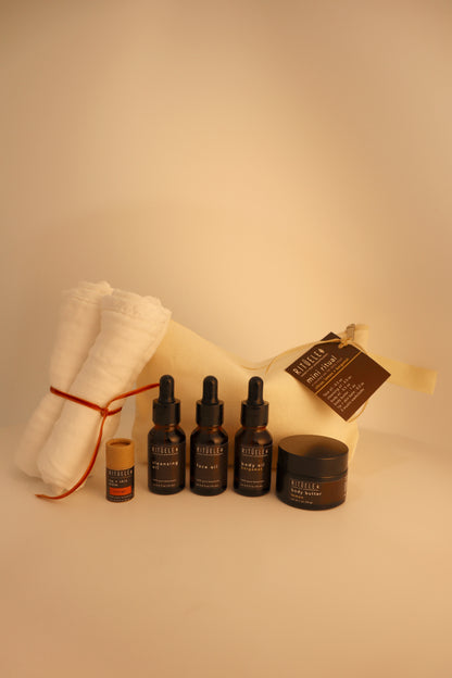 travel pack of small body oil, small face oil, small face cleansing oil, small body butter, small lip balm and 3 towelettes