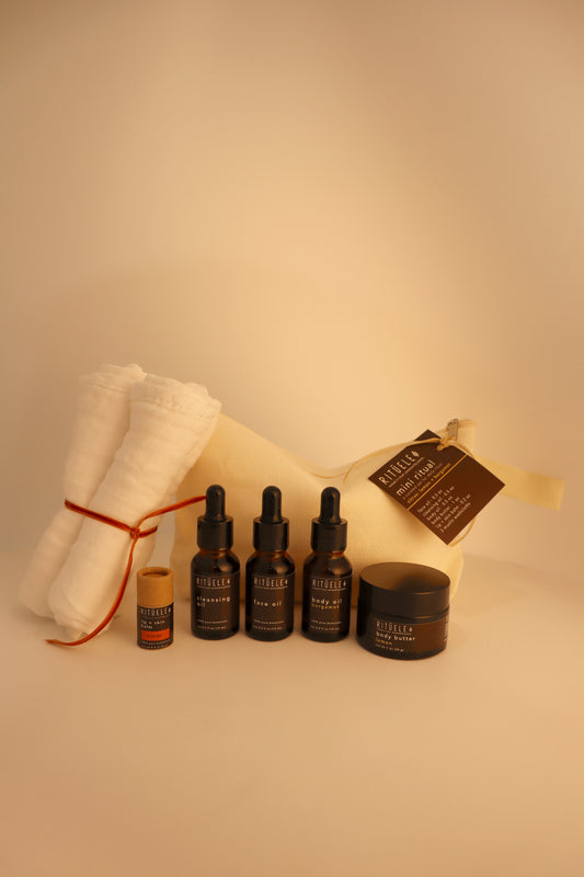 travel pack of small body oil, small face oil, small face cleansing oil, small body butter, small lip balm and 3 towelettes