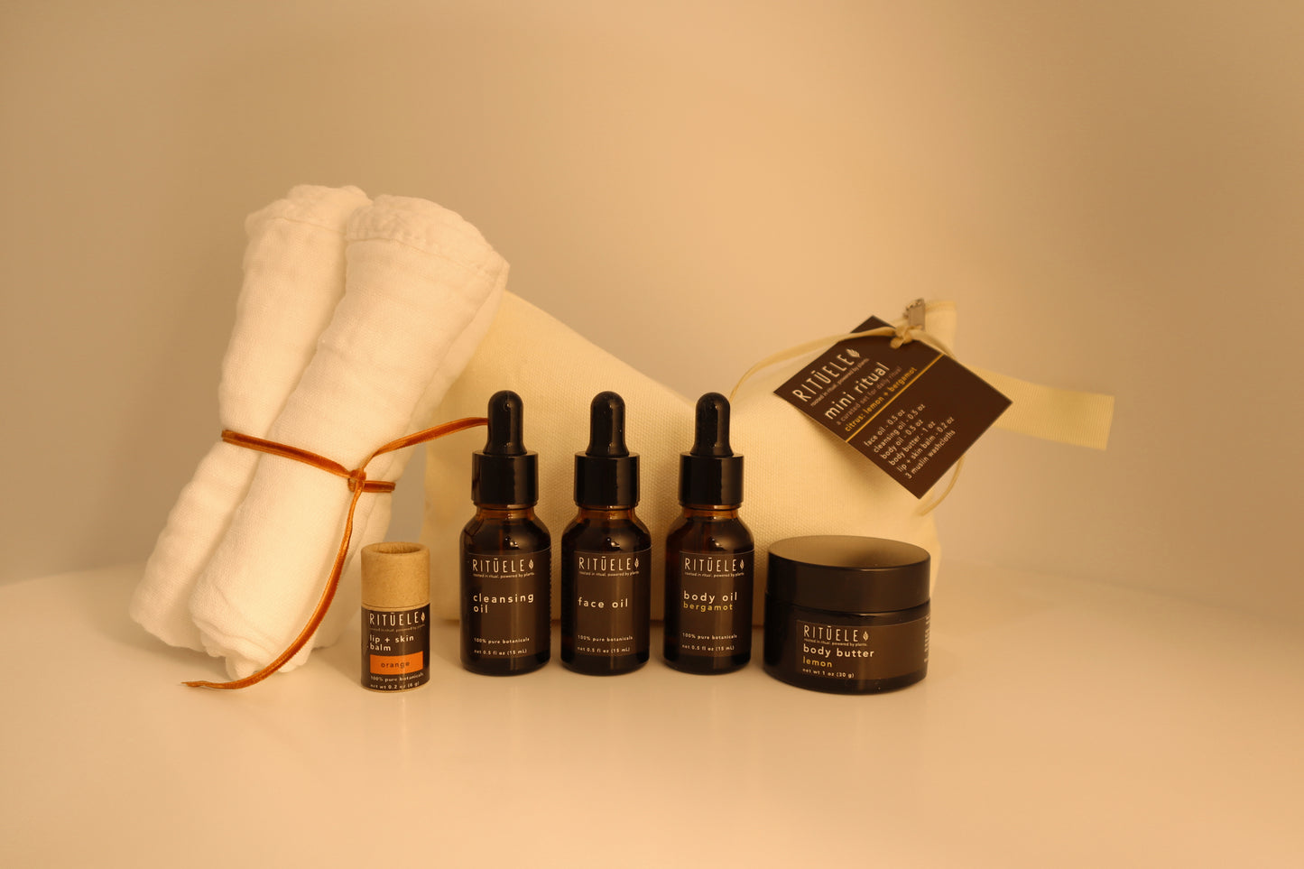 travel pack of small body oil, small face oil, small face cleansing oil, small body butter, small lip balm and 3 towelettes